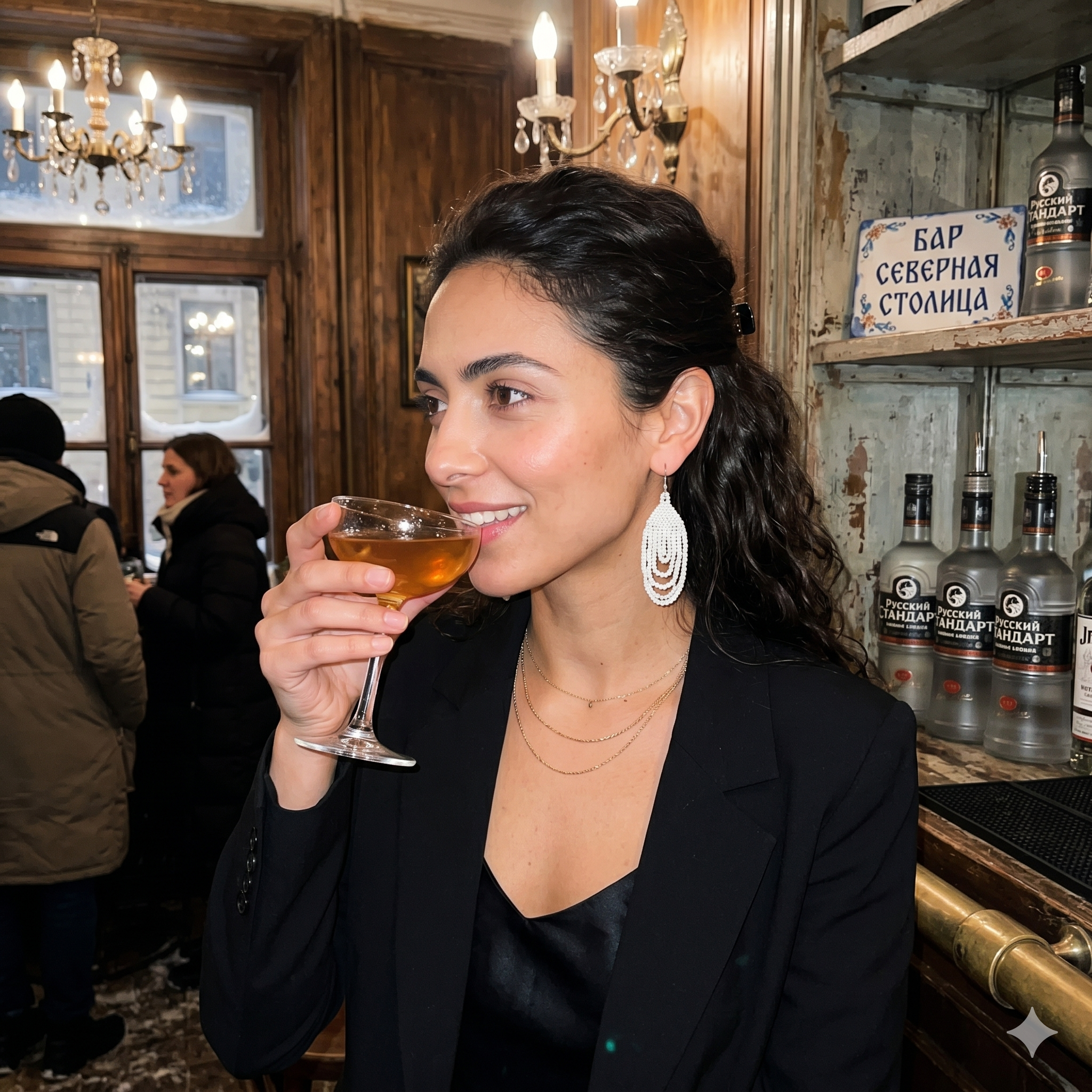 Gros plan sur une femme vêtue d'un blazer noir portant les boucles d'oreilles blanches Zenka dans un bar sophistiqué à Saint-Pétersbourg.